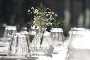 Elegant table setting with a floral centerpiece and classy glassware photo