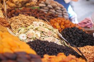 A Vibrant and Colorful Display of Dried Fruits and Nuts at a Market Stall photo