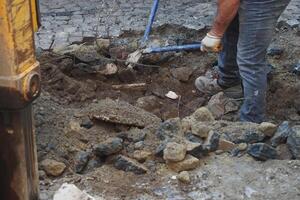 The Excavation Work Involves Heavy Machinery Usage and Manual Labor Efforts photo