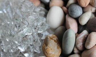 Growths On A Icicle Lying On Smooth Pebbles Macro Shot Stock Photo
