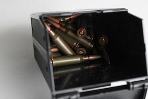 Scattered Bullet Cartridges Inside Black Ammo Case Closeup View photo