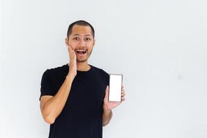 Young men get surprised with empty white blank screen smartphone on isolated background photo