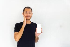 Young men get surprised with empty white blank screen smartphone on isolated background photo