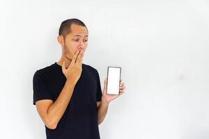 Young men get surprised with empty white blank screen smartphone on isolated background photo