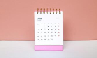 January month first of year 2025 in calendar 2025 in pink isolated on pink background. Calendar and Note Pad Happy New year 2025. Zoomed in first of january 2025 in calendar photo
