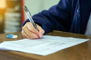 Thai students take a knowledge test to assess knowledge skills. The result of the exam will come out as a score value. Allows us to analyze the results or grade. Soft and selective focus. photo