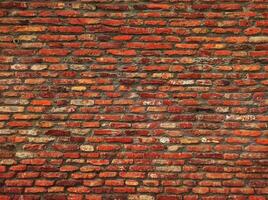 Red brick wall. Texture of old dark brown and red brick wall panoramic backgorund.Old red brick wall background, wide panorama of masonry.red brick wall texture grunge background. photo