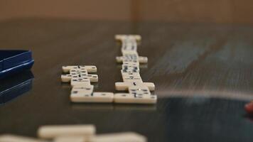 Domino pieces set up for a strategic tabletop game on a reflective surface photo