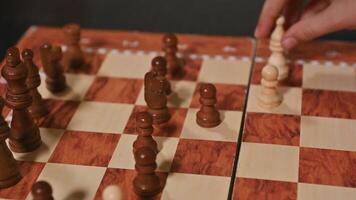 Chessboard view with wooden pieces being moved during an intense game photo