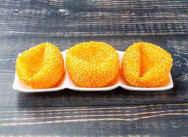 Fried Dumplings with sesame seeds served in tray dish isolated on wooden table side view of hong kong food photo