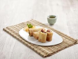 Crispy Spring Roll with Peking Duck and sauce served in a tray isolated on mat side view on grey marble background fast food photo