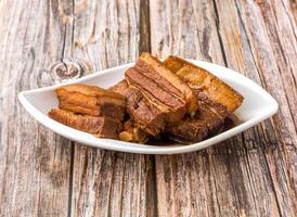 Dongpo Pork served in dish isolated on wooden table side view of hong kong food photo