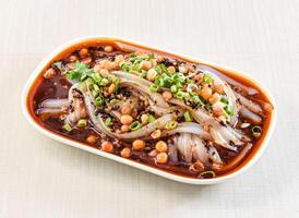 Northern Sichuan jelly topped with chickpeas, scallions and coriander served in tray dish isolated on white background side view of hong kong food photo