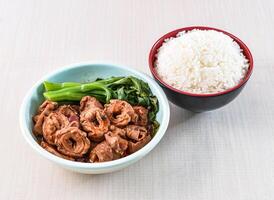 Braised pork intestine with white rice and kailan served in bowl isolated on white background side view of hong kong food photo