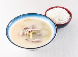 Pepper Pork Belly Soup with white Rice served in bowl isolated on white background side view of hong kong food photo