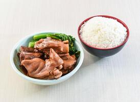 Braised Pork Knuckle whit white Rice and kailan served in bowl isolated on white background side view of hong kong food photo