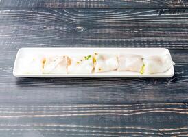 Shrimp Intestines Rolls served in tray dish isolated on wooden table side view of hong kong food photo
