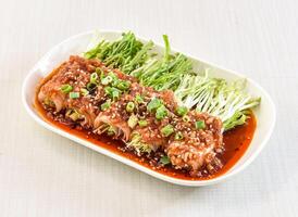 Garlic Pork rolls topped with herbs, green onion and sesame seeds served in tray dish isolated on white background side view of hong kong food photo