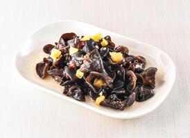 Hot and sour cloud fungus served in tray dish isolated on white background side view of hong kong food photo