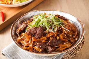 Stir fried Beef River with Swiss Sauce served in bowl isolated on napkin side view of hong kong food on wooden background photo