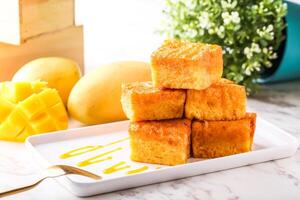 Mango Gold Brick west Toast Stack served in tray dish with fork isolated white marble background side view of hong kong food photo