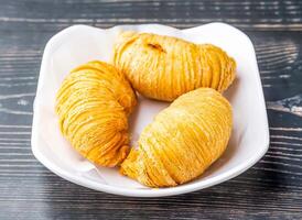 Golden Carrot Puff Pastry served in dish isolated on wooden table side view of hong kong food photo