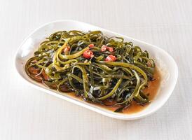 Cold Seaweed Salad sherds served in tray dish isolated on white background side view of hong kong food photo