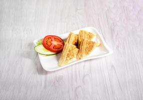 Crispy Grilled Cheese Sandwiches with tomato, cucumber and cabbage served in tray dish isolated on wooden table side view of hong kong food photo