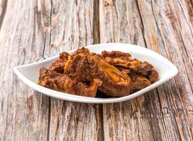 Braised Beef Brisket or Sirloin served in dish isolated on wooden table side view of hong kong food photo