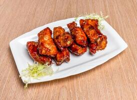 Peking Pork ribs and salad sauce served in tray dish isolated on wooden table side view of hong kong food photo