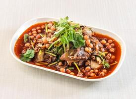 Fuqi Feipian or Sichuan Spicy Beef Salad with coriander and chickpeas served in tray dish isolated on white background side view of hong kong food photo