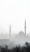 A silhouette of a Middle Eastern city skyline with classic domed buildings and tall minarets against a foggy, gray background on a winter morning, with a subtle frost effect photo