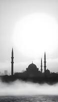 A silhouette of a Middle Eastern city skyline featuring domed buildings and tall minarets against a foggy, gray background during early morning with soft light illuminating the fog photo