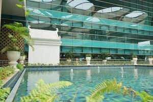 a large building with a pool in front of it at the new yogyakarta international airport photo