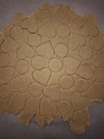Preparing heart and circle shaped cookies from dough on baking paper for valentine's day photo