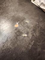 Damaged countertop showing peeling laminate and particleboard underneath photo