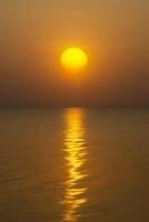 Sunset at the lake with reflection light on water surface. photo