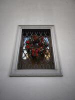 Christmas wreath hanging on a window with metal grille in prague castle photo