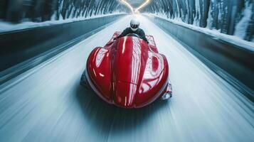 Professional bobsledder driving red bobsleigh at high speed in icy tunnel photo
