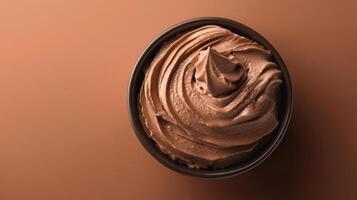 Creamy chocolate ice cream swirling in a bowl, a sweet frozen dessert photo