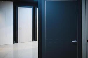 The samples of various wooden doors in the exhibition area of a store photo