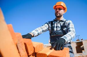 Construction worker in uniform and safety equipment have job on building photo