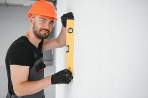 Construction Worker in uniform with spirit level photo