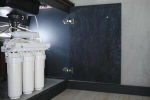 Reverse osmosis water purification system at home. Installed water purification filters. Clear water concept photo