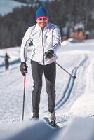 Man practices Nordic skiing with classic technique photo