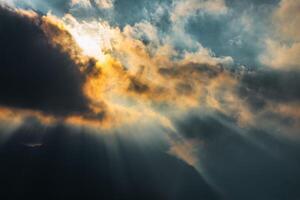 Divine rays of sun between the clouds photo