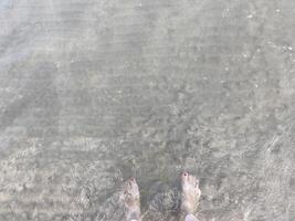 Feet in the clear transparent sea photo