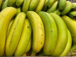 Banana branches in a crate at the store photo