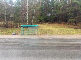 An empty stop near the woods photo
