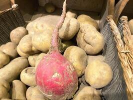 A pack of potatoes and radishes from the market or grocery store photo